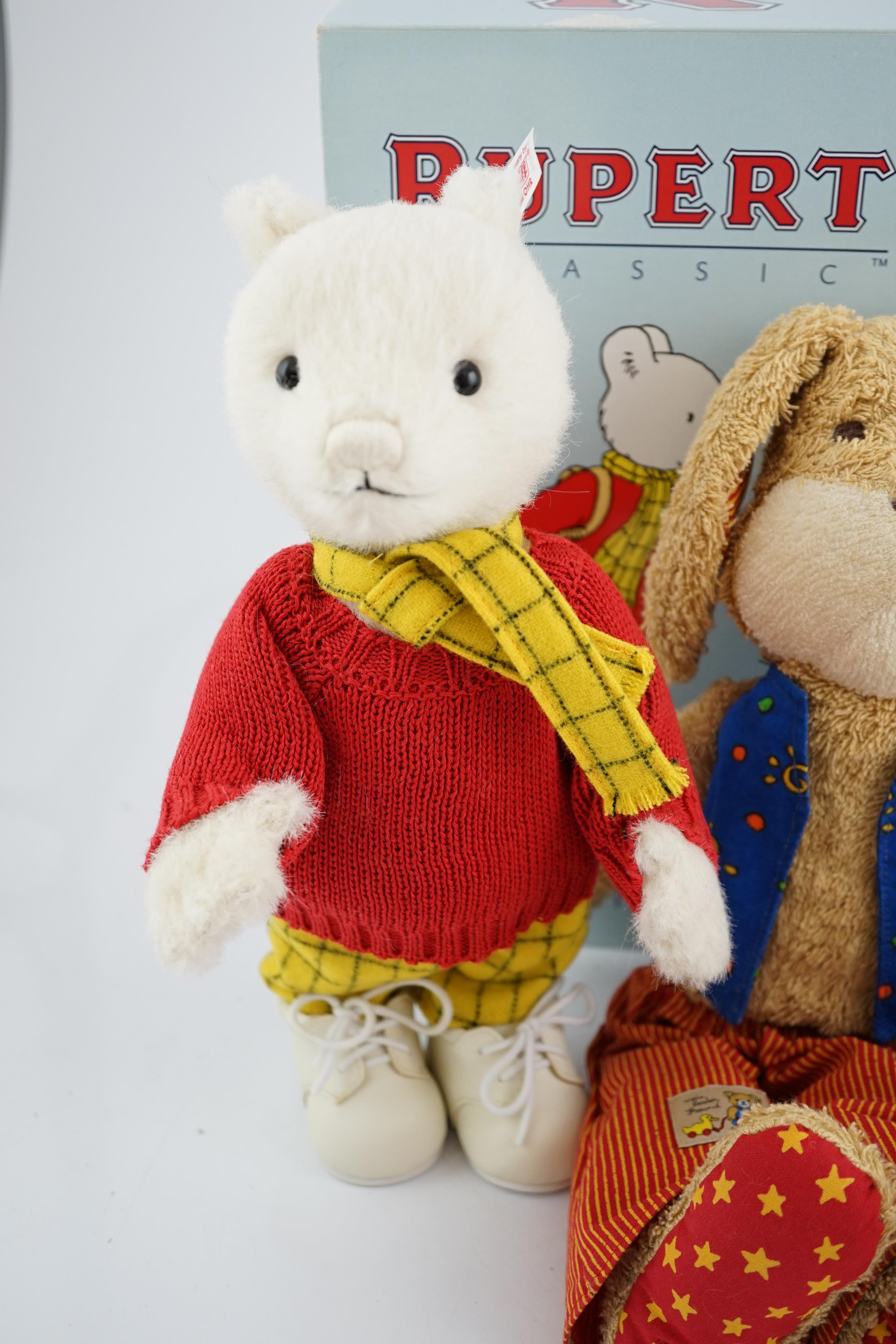 Four Steiff toys including Boxer dog and Rupert Bear